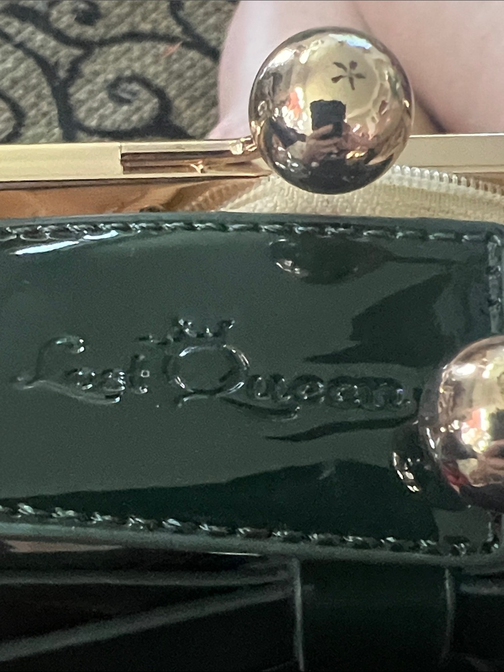Last Queen black handbag features a patent vinyl finish